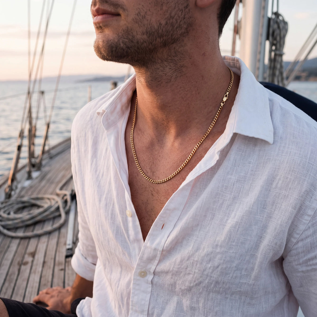 Curb chain necklace, gold, worn on a boat
