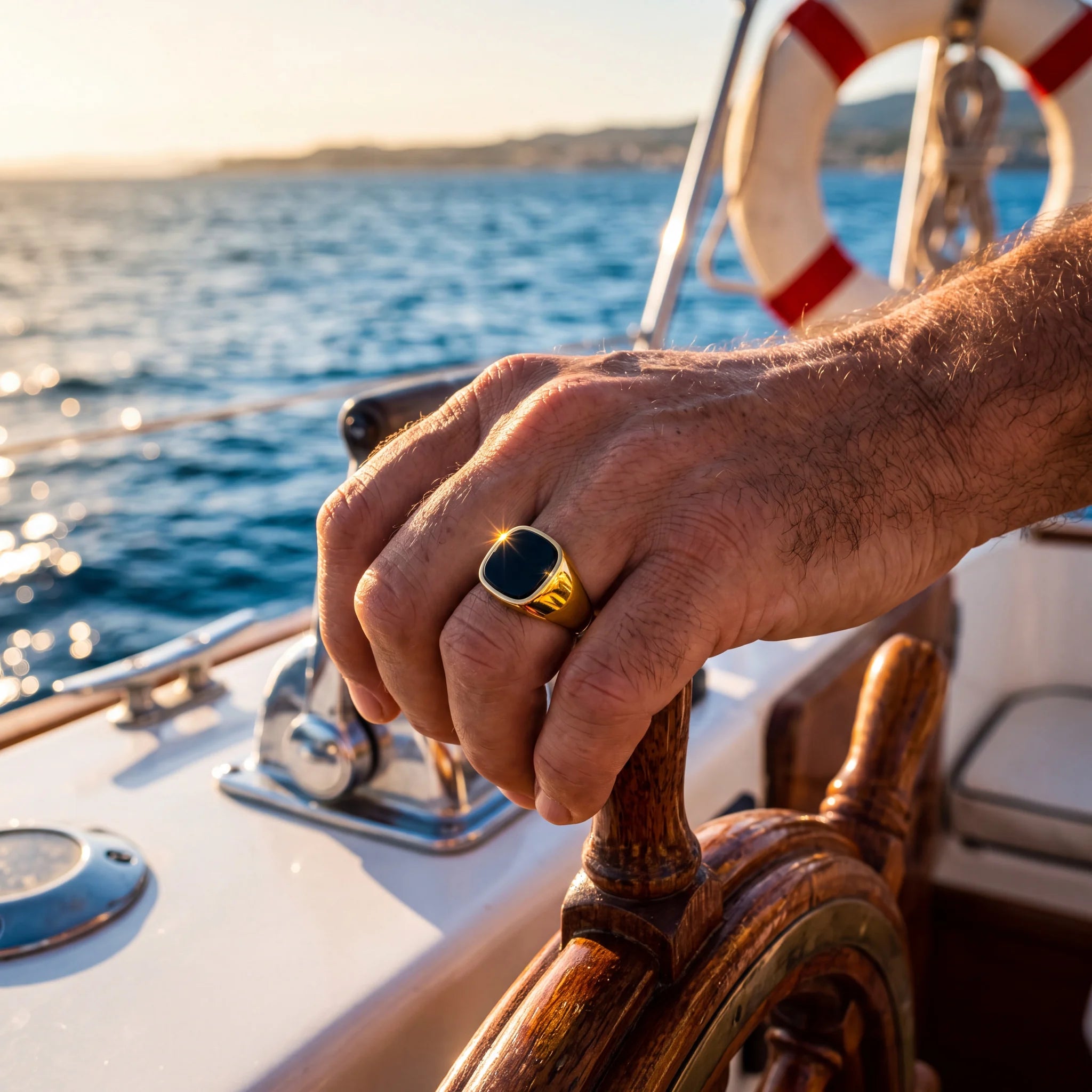 Black stone signet ring, gold, worn on a boat