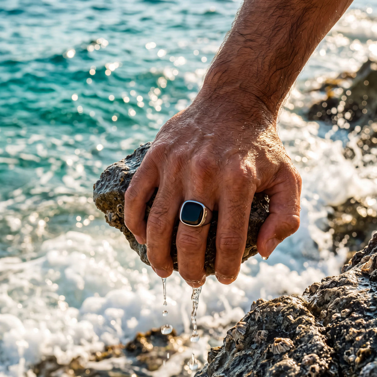 Black stone signet ring, silver, worn at the sea